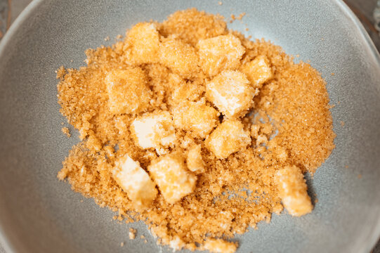 Crumbled Brown Sugar And Cubes In Ceramic Bowl, Warm Golden Tones, Artisanal Baking Ingredient, Coarse