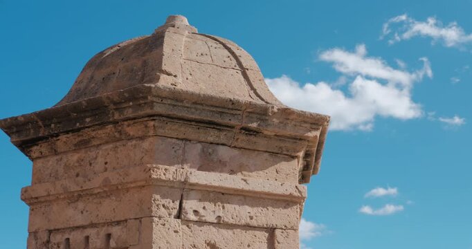Detailed view of loophole architecture detail in Palma de Mallorca, Majorca, Spain. Clear blue sky and white clouds.