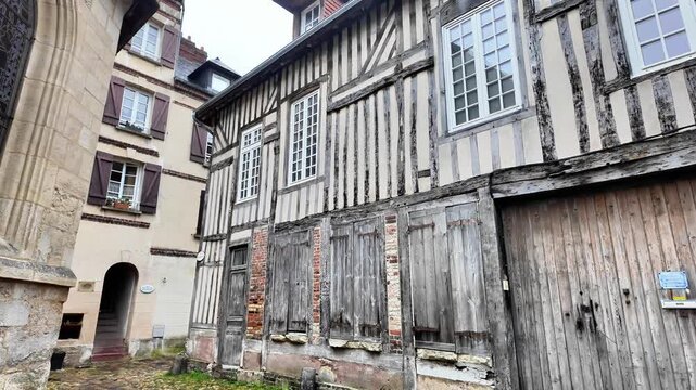 Panning shot revealing traditional half-timbered architecture and a picturesque inner courtyard.