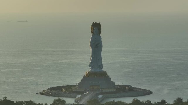 Aerial footage of Guanyin statue at seaside in nanshan temple, hainan island , China. Words mean mercy and blessing.