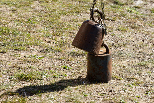 Rusty counterweights from windmill balancing on ground
