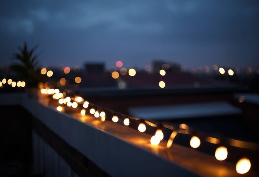 Bokeh of string lights on night terrace and city lights