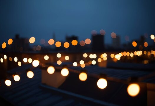 Bokeh of string lights on night terrace and city lights
