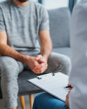 Man consulting doctor in modern minimal clinic