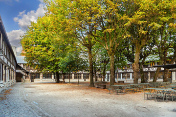 Obraz premium Aitre Saint-Maclou courtyard in Rouen, France. Historic timber framed gallery view under a partly cloudy sky