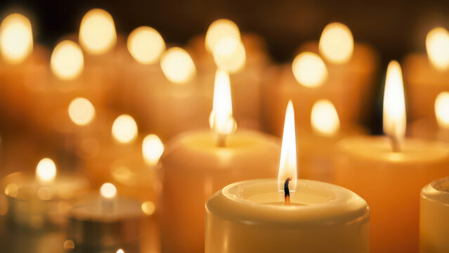 Burning memorial candles in dark background with warm golden light bokeh, symbolic remembrance scene for mourning, prayer and spiritual reflection, tribute to memory, grief support and peaceful vigil