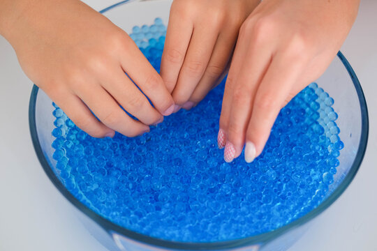 Child play with blue Orbeez balls.