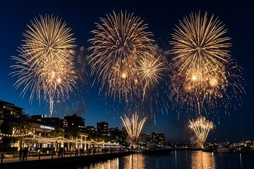 Fototapeta premium Fireworks explode above city skyline at night over water