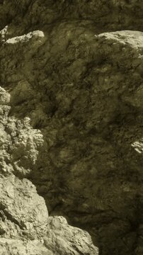 An intriguing view of natural rock formations showcases a palette of earthy tones. The rough textures and shadows create a captivating scene, inviting exploration of natures wonders.