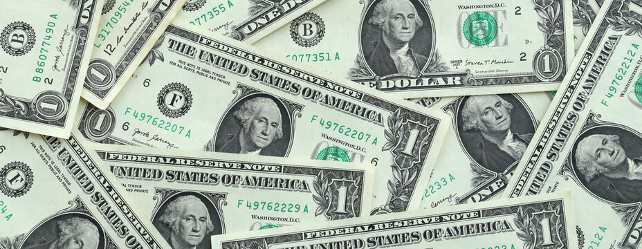 US one dollar money banknotes pile on table. United States bills of USD currency close up