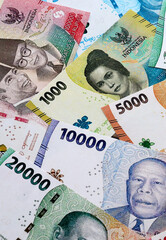 Indonesian rupiah money banknotes pile on table. Indonesia bills of IDR currency close up © Larysa