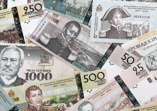 Haitian gourde money banknotes pile on table. Haiti bills of HTG currency. Concept of economy