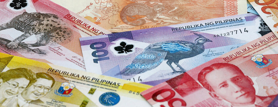 Philippine peso money banknotes pile on table. Philippines bills of PHP currency close up