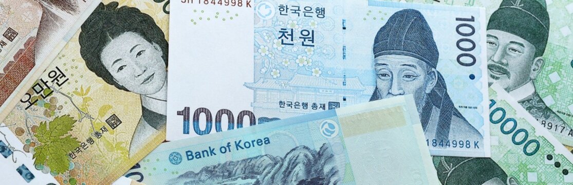 South Korean won money banknotes pile on table. South Korea bills of KRW currency close up