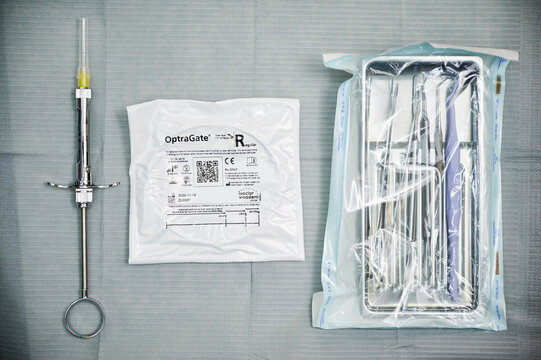 Dental syringe, OptraGate pack, and sterile instruments on tray