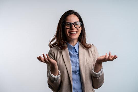 Excited young businesswoman wearing AI smart glasses, isolated shot