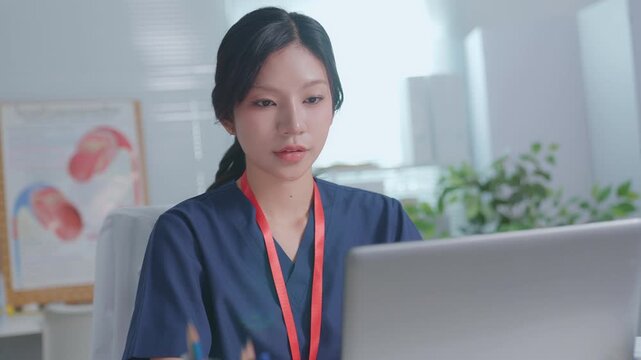 Beautiful asian woman doctor entering electronic medical records. Medical, asia female working with computer in medical consultation at hospital. which are recording diagnosis and patient symptoms.