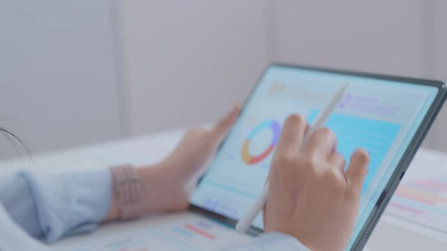 ฺBlur Close up. financial advisor or crypto trader holding digital tablet in hands consulting stock market investor analyzing trade charts dynamic indexes investing trends on tab screen. Business anal
