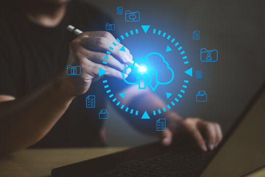 Professional man using stylus for cloud data backup and file sync with advanced holographic interface on laptop