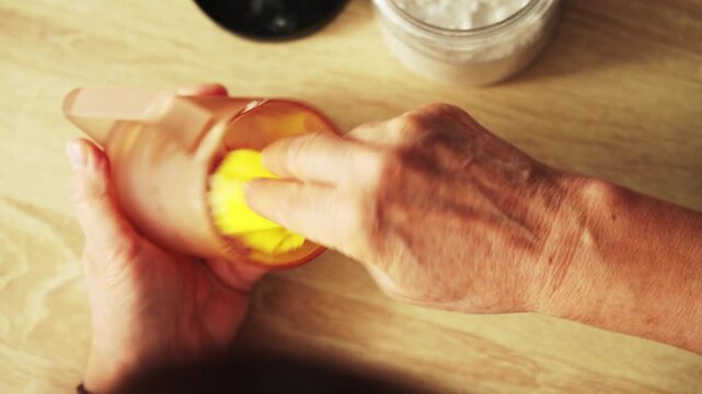 Preparing a drink with fresh lemon on a wooden kitchen counter during the day