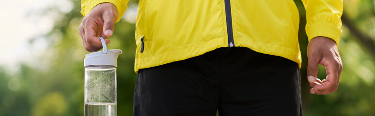 Young african american man in yellow windbreaker energizes spring workout outdoors © LIGHTFIELD STUDIOS