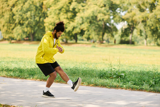 Young man enjoying an active spring day in his bright yellow workout gear outdoors