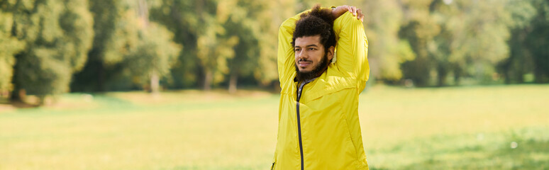 Vibrant workout in spring sun with a young man in a yellow windbreaker outdoors © LIGHTFIELD STUDIOS