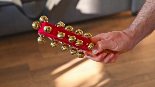 Slow Motion Video of Man Shaking Sleigh Bells Close Up