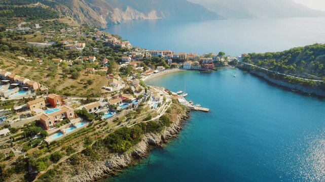 Aerial of Assos village by the bay with colorful houses on Kefalonia island