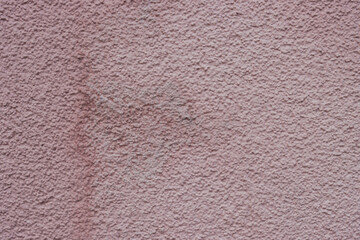 Fototapeta premium Rough, textured wall in muted earth tones