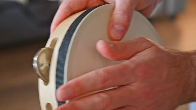 Man Playing Tambourine with Fingers Close Up