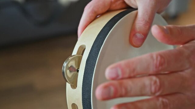 Slow Motion Video of Man Playing Tambourine with Fingers Close Up