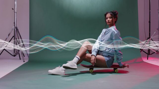 Camera rolling, model sitting on board posing with moving wave sweeping across model for fashion