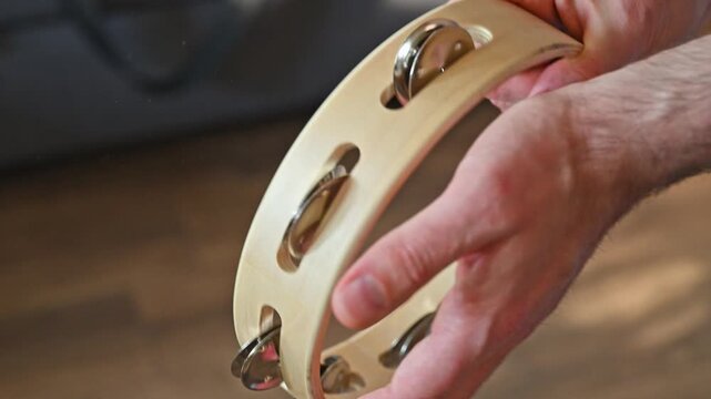 Man Shaking Wooden Tambourine Close Up