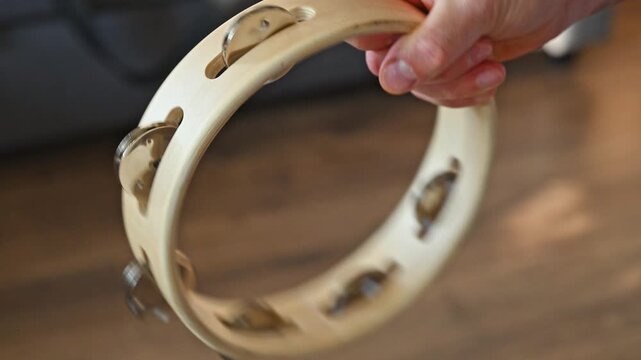 Man Shaking Wooden Tambourine Close Up 2