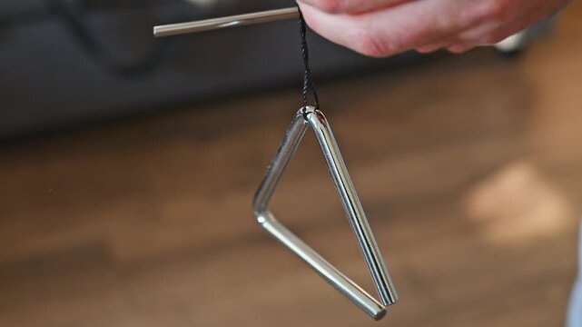 Slow Motion Video of Man Playing Triangle Close Up