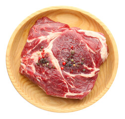 Obraz premium Raw ribeye beef steak and peppercorns isolated on white, top view