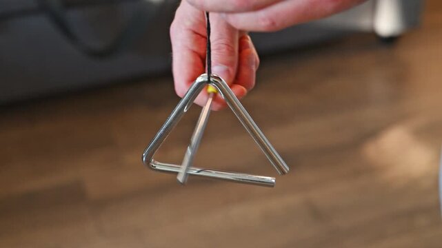 Man Playing Triangle Close Up 2