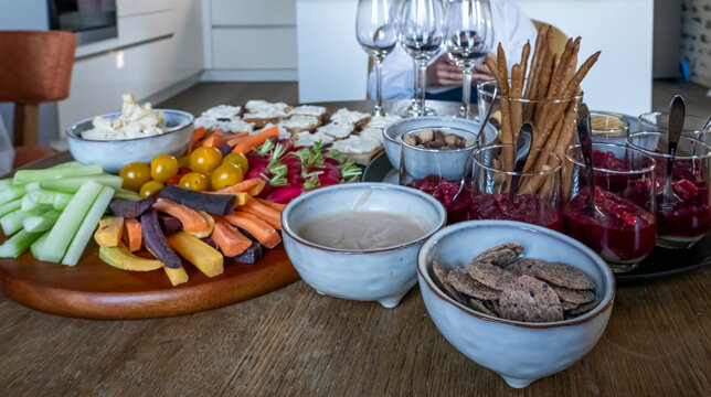 Charencey, France - 04 10 2026: A wooden table set for an appetizer featuring fruit, vegetables, toasts, salads, cheeses in a charming guest house in Le Perche region