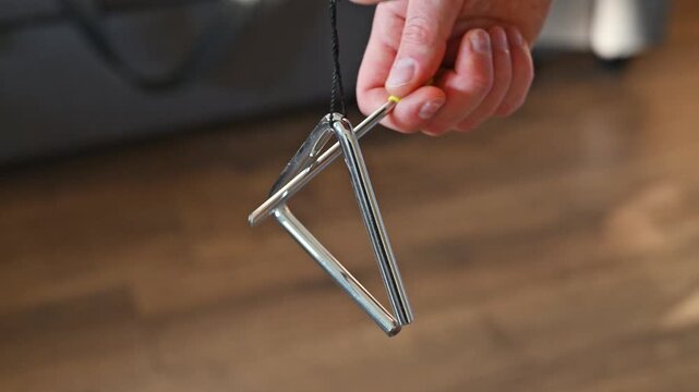 Slow Motion Video of Man Playing Triangle Close Up 2