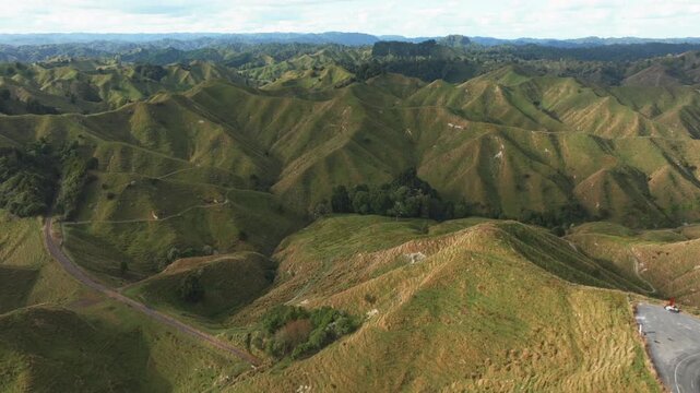 Rolling green hills and valleys at the Tahora Saddle, Manawatu-Whanganui, New Zealand. showcasing the country's lush agricultural landscape and natural beauty. ,