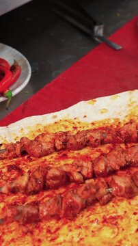 Placing Juicy Lamb Kebab Skewers on Fresh Flatbread Vertical Video