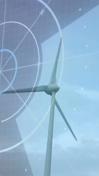 Vertical video: Turbine rotating under breeze camera shifting, HUD tracking blades for energy data