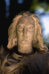 Fototapeta premium Angel statue in soft light and shadow, concept of protection, calm and spiritual presence.