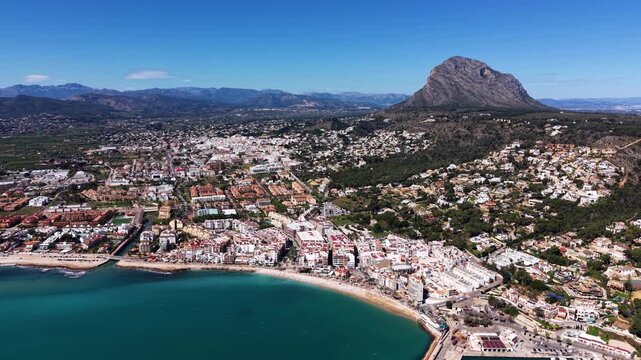 Aerial view of Xabia on the Costa Blanca, Spain, showing turquoise Mediterranean bay, sandy beach, white town buildings, marina and iconic Montgo mountain backdrop
