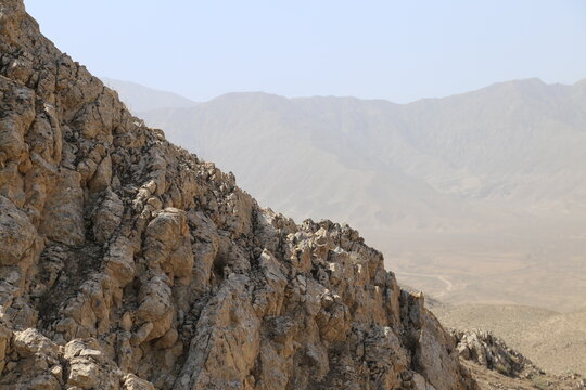 Texture of rough rock face in arid mountains.
