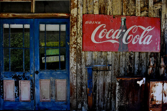 Old derelict Convenience store with 1930-1940&rsquo;s era rectangular metal Coca-Cola metal sign 