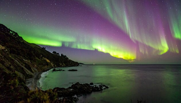 vibrant aurora australis steve phenomenon over coastal mountains at night