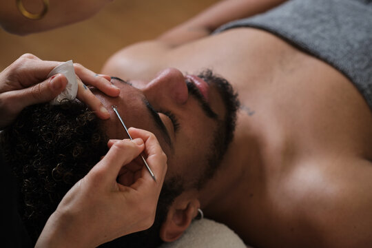close up of Man relaxing during a facial extraction procedure at a spa
