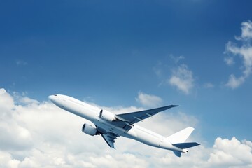 Fototapeta premium Aircraft Takes off Into the Blue Sky With Clouds in the Distance During a Sunny Day